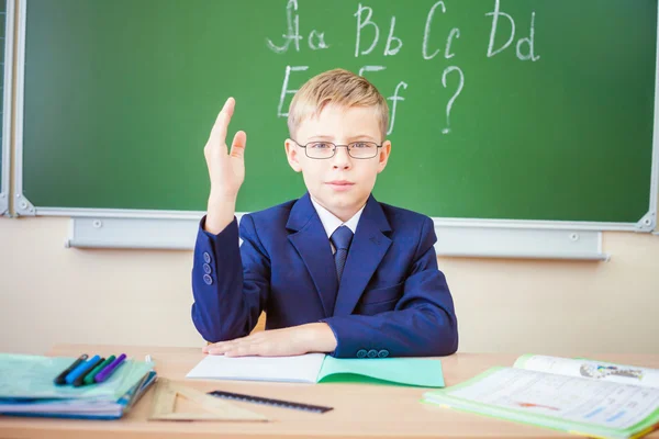 Schoolboy ready to answer and raised hand up — Stok fotoğraf