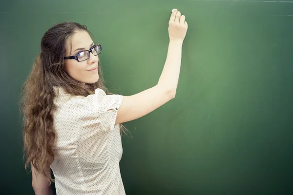 Teacher or student wrote on blackboard with chalk at classroom — Stok fotoğraf