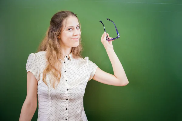 Pretty teacher or student holding glasses at classroom, university — Stok fotoğraf