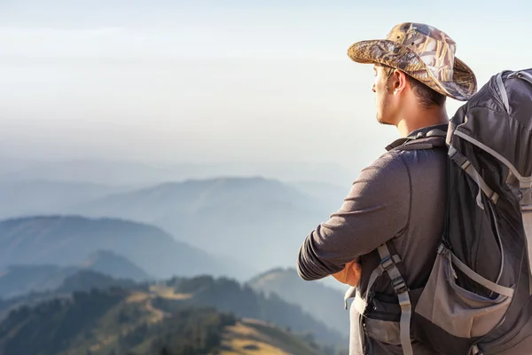 Climbing young adult at the top of summit — Stock Photo, Image
