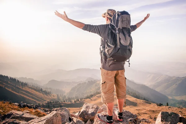 Climbing young adult at the top of summit — Stock Photo, Image