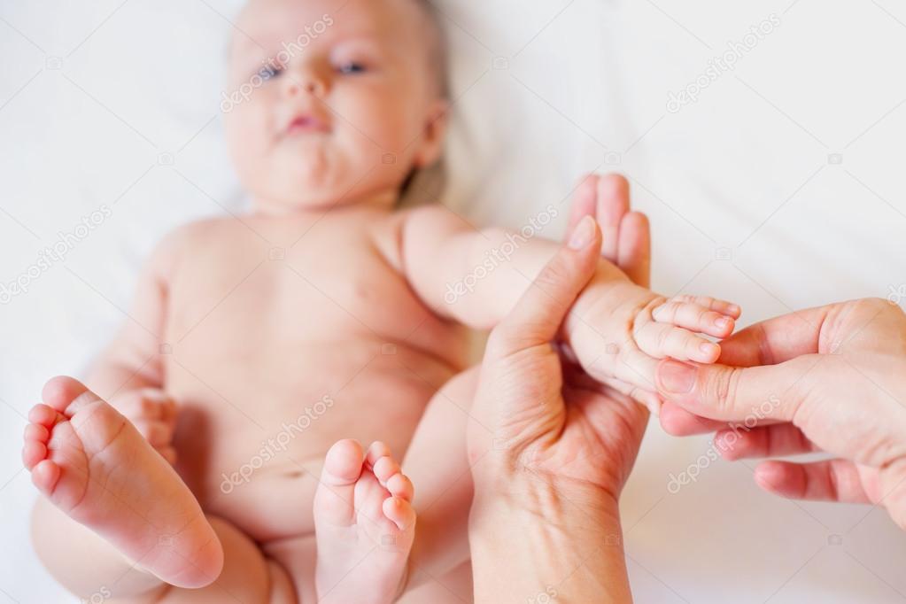 Mother makes finger massage for baby 
