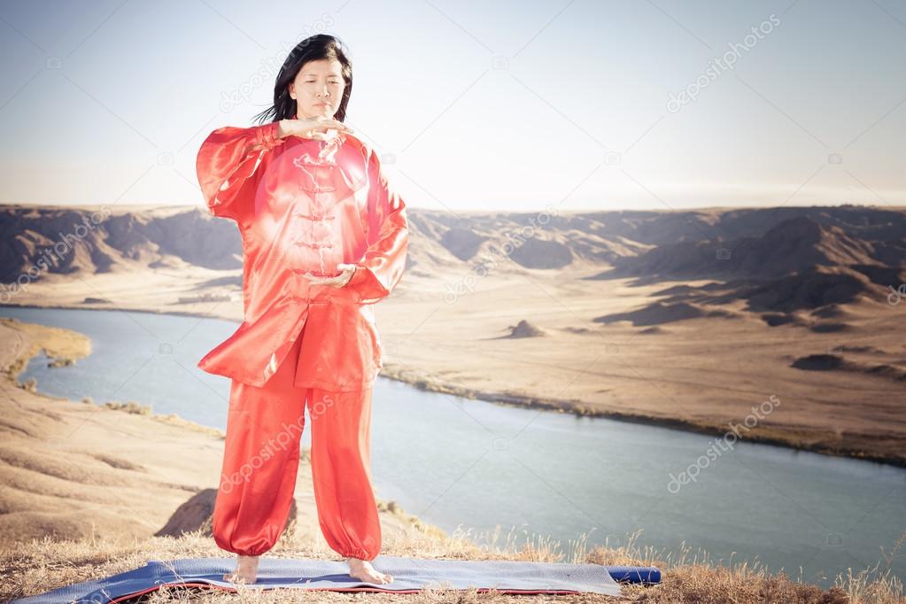 Mature asian woman doing kundalini yoga