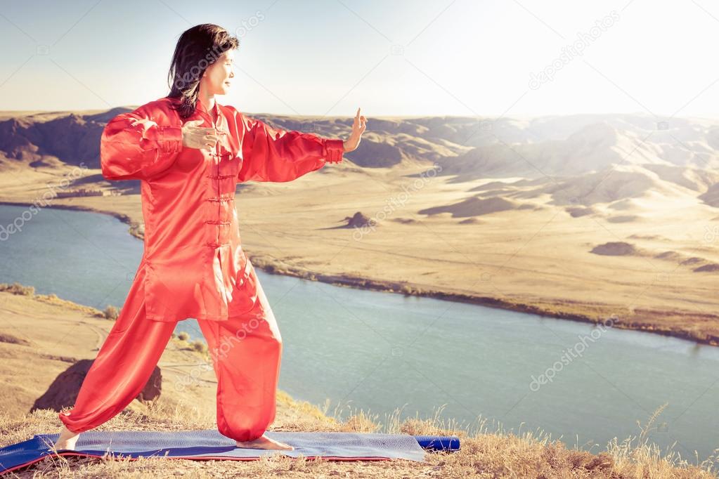 Mature asian woman doing kundalini yoga