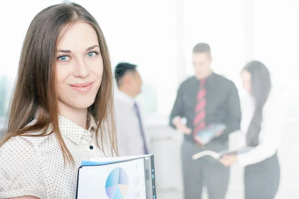 Successful businesswoman at foreground and business team at background — Stock Photo, Image