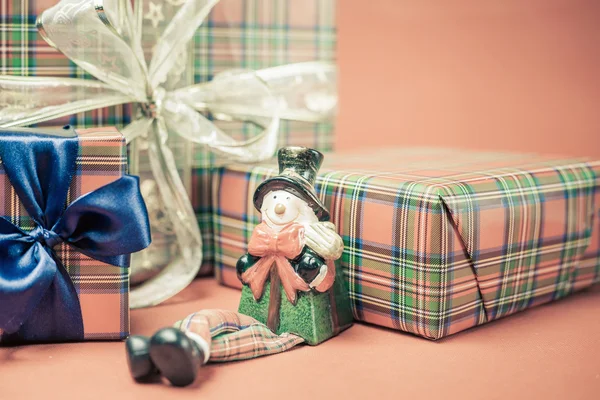 Caja de regalo de Navidad con muñeco de nieve juguete en fondo rojo —  Fotos de Stock