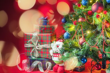 Decorated christmas tree with gift boxes and Santa Claus toy