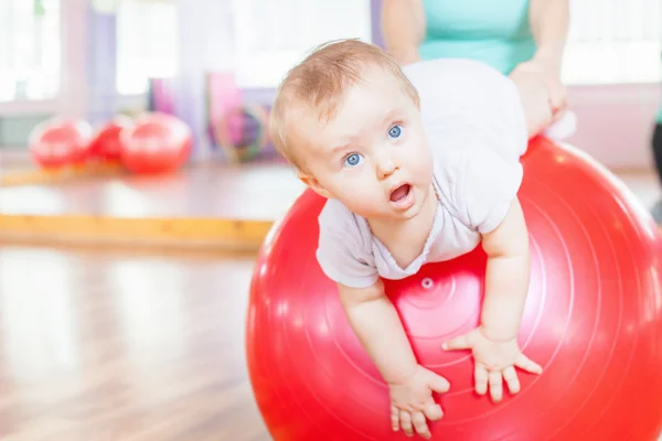 Mother with happy baby doing exercises with gymnastic ball — Stock Photo, Image