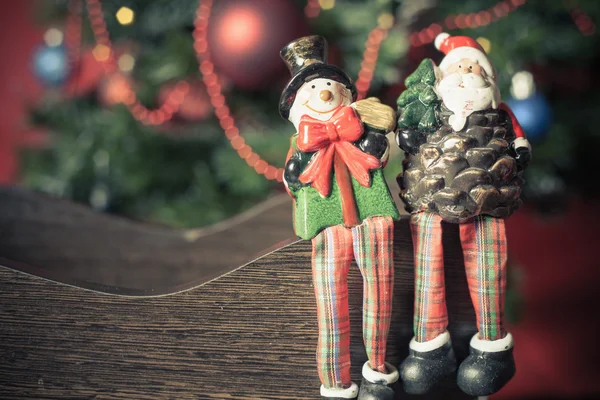 Christmas toy Santa Claus and snowman at Christmas eve — Zdjęcie stockowe