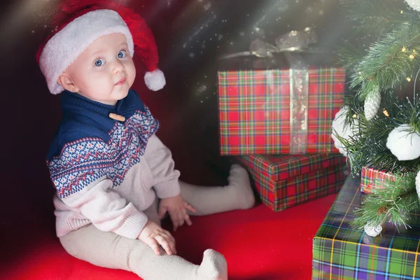 Ευτυχισμένο μωρό με πολλές κουτί δώρου δίπλα στολισμένο χριστουγεννιάτικο δέντρο — Φωτογραφία Αρχείου