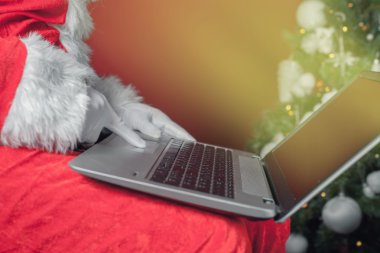Santa Claus using laptop computer