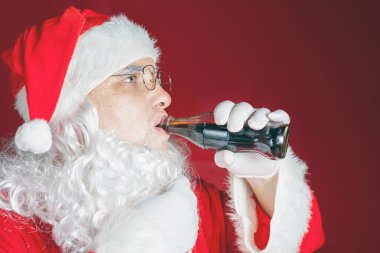 Santa Claus drinking Coca Cola fresh beverage, Christmas holiday