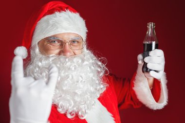 Cool and funny Santa Claus holding Coca Cola, Christmas holiday