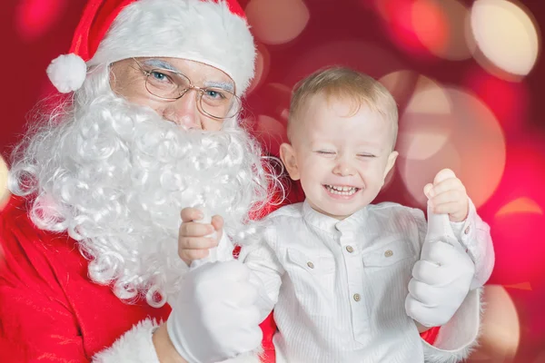 Cool little boy and Santa Claus at Christmas holiday — Φωτογραφία Αρχείου