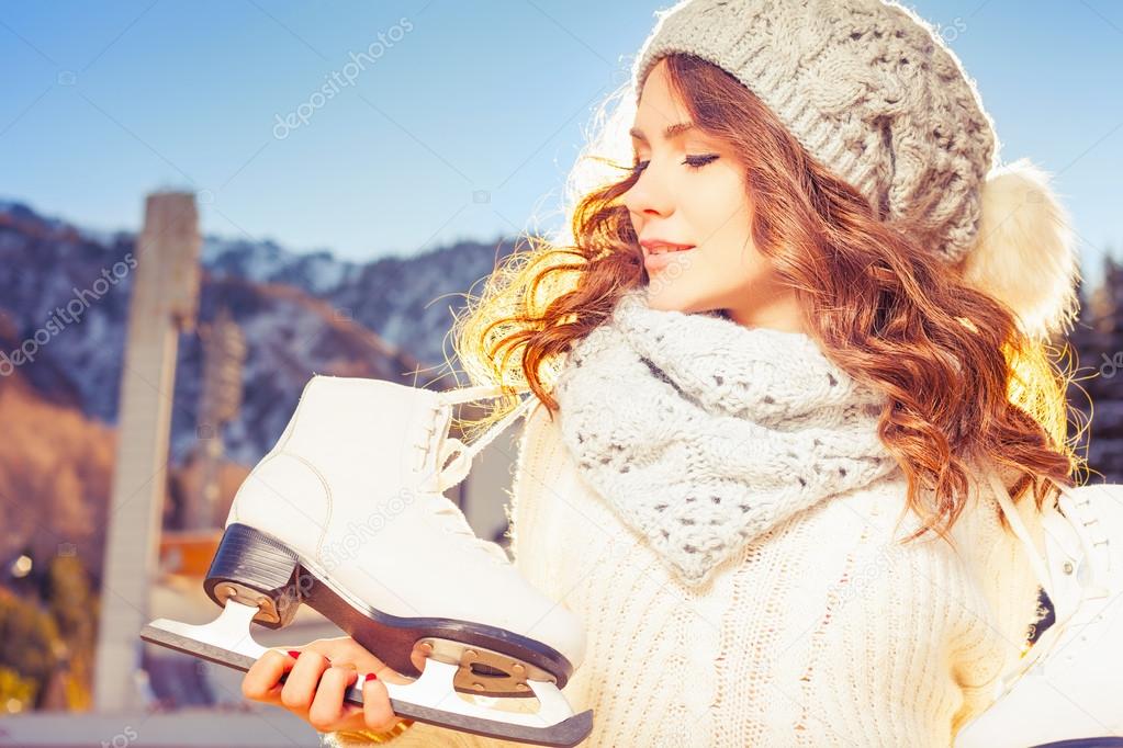 Beautiful caucasian woman going to ice skating outdoor