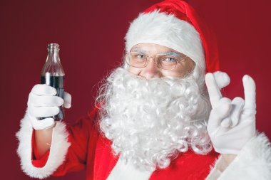Cool and funny Santa Claus holding Coca Cola, Christmas holiday