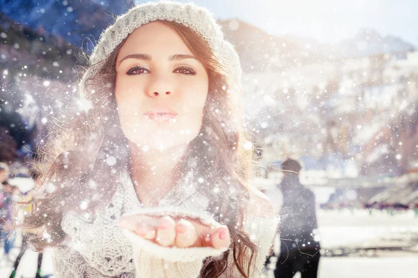 Beautiful girl blowing of snow and snowflakes, winter — Stock Photo, Image