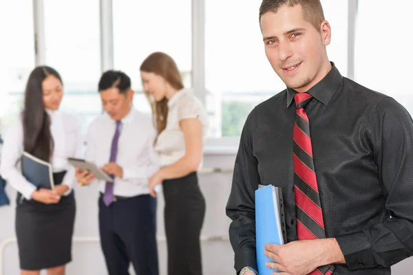 Successful young business man and his business team — Stock Photo, Image