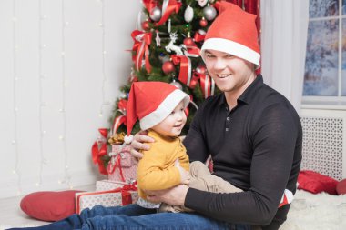 Happy father with son at Christmas eve sitting together