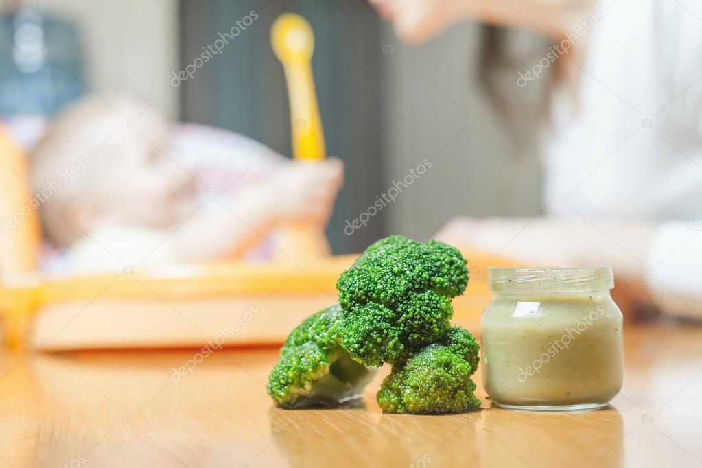 Mom feeds the baby soup. Healthy and natural baby food