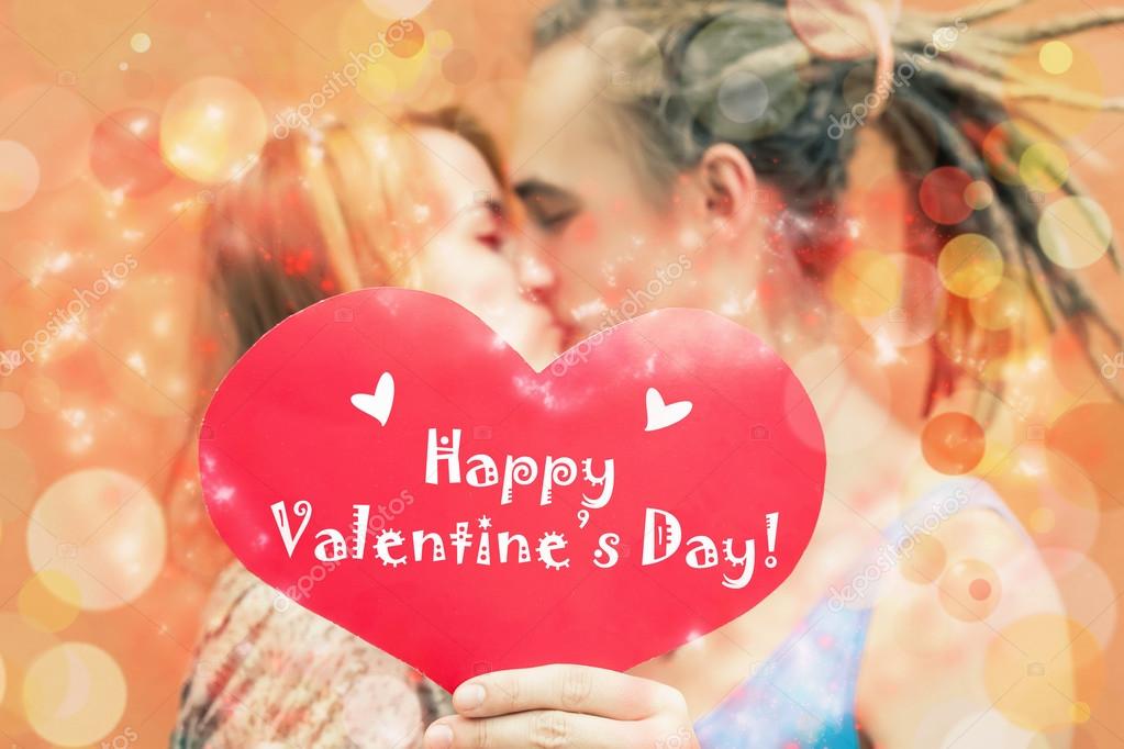 Happy Valentines Day couple holding red heart symbol — Stock Photo - Main Image