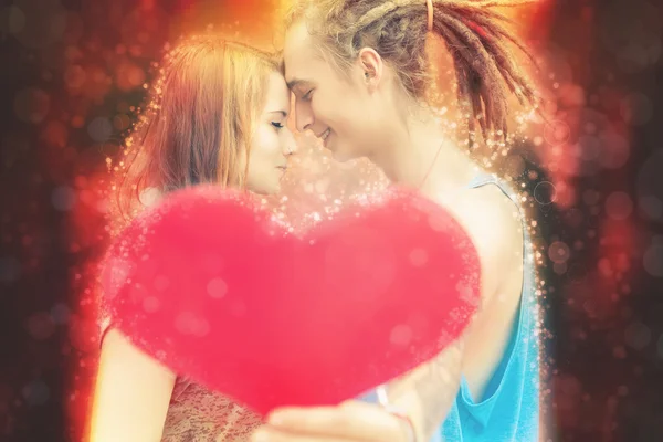 Happy Valentines Day couple holding red heart symbol — Stock Photo, Image