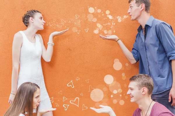 Small group of young people sending kiss to each other — Stock Photo, Image