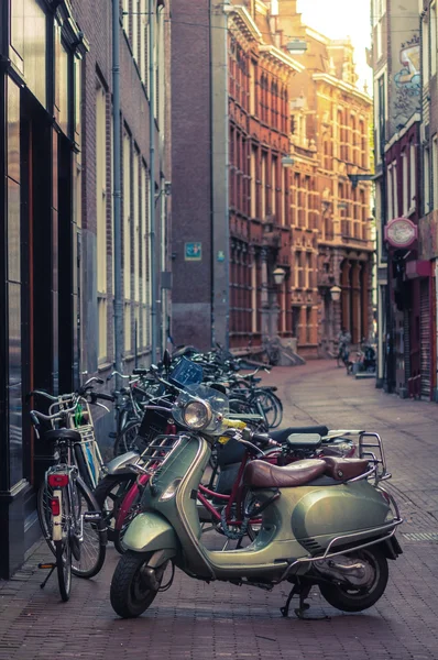Moped parked on a street Stock Picture
