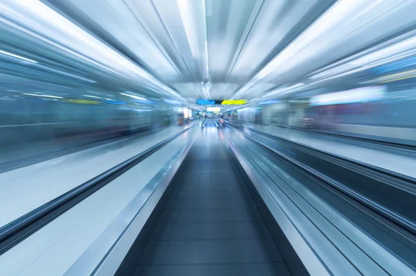 Blurred movement along airport walkway Stock Photo