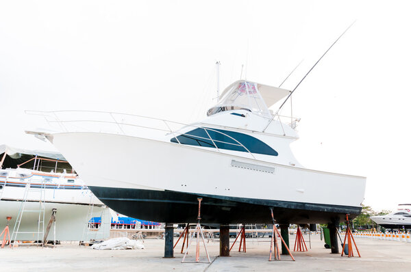 Small motorboat at the shipyard waiting for maintenance