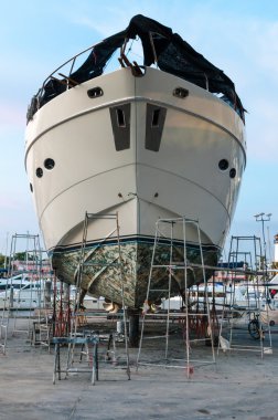 Yacht at the shipyard for maintenance clipart