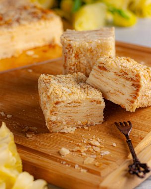 Tahtadaki sarı çiçekli ballı kek parçaları.