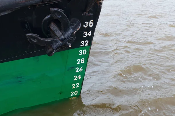 Floating ship with draft measurement scale at the bow
