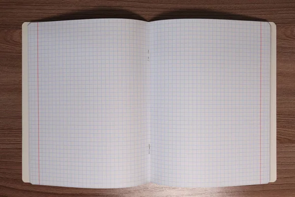 Caderno Checado Uma Mesa Madeira Marrom — Fotografia de Stock