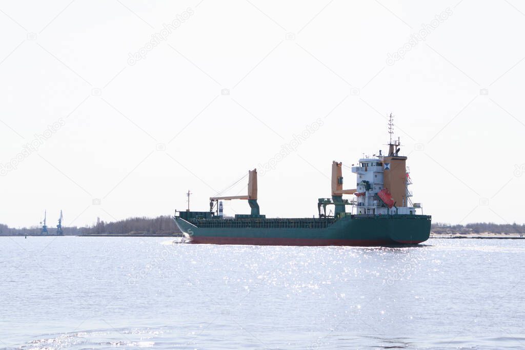 A large cargo ship enters the port.