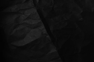 Siyah buruşmuş kağıt dokusu. Koyu renk duvar kağıdı.