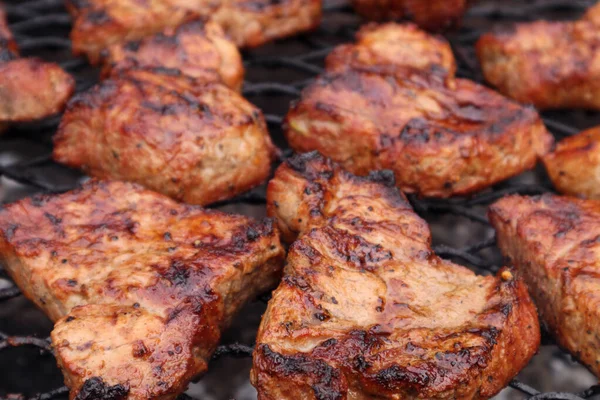 stock image Pork neck chops steaks on the grill. Soft focus.