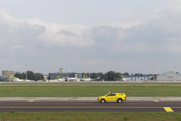Riga International Airport Yellow Car Service Staff Drives Runway Which — Stock Photo, Image