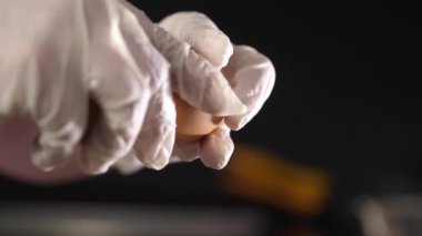 Aşçı bir tavuk yumurtasının kabuğunu kırar. Protein ve yumurta sarısı döker..