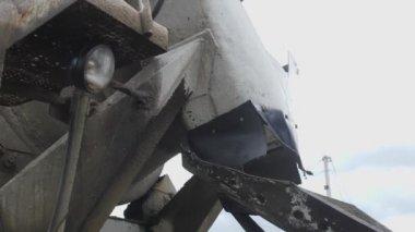 Concrete is poured from a concrete mixer into a metal container