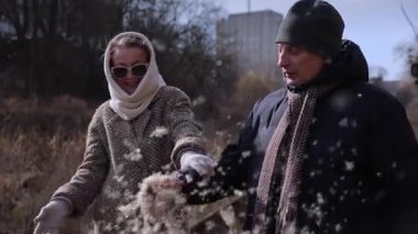 Olgun bir adam, sonbahar parkında karısını eğlendirmek için kuyruğunu sallar. Gülümseyen ortağı olan yaşlı beyefendi nehir kenarında uçuşan aynasızların keyfini çıkarıyor. Emeklilik yaşam tarzı