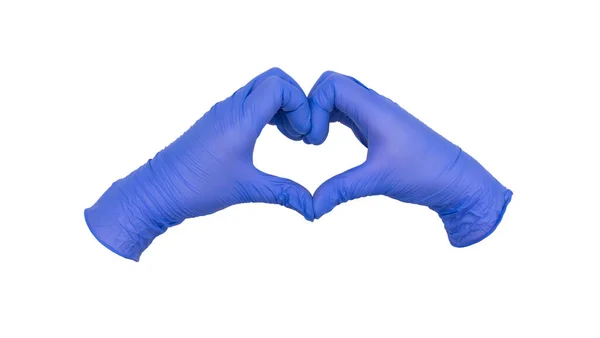 戴着蓝色硝酸铵检测手套的双手携起手来 做一个爱心或爱心的手势 免版税图库图片