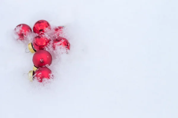 Postcard, frame for your Christmas greetings with red balls in the snow — Stock Photo, Image