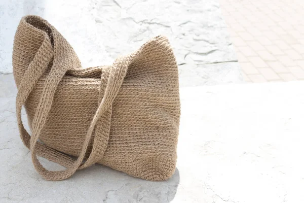 A bag made of jute. Handmade, crocheted. Eco-friendly shopping bag for going to the grocery store.