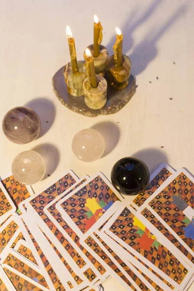 Tarot Setup Background. Tarot cards, candles, magic balls made of natural stone for divination or a magical ritual.