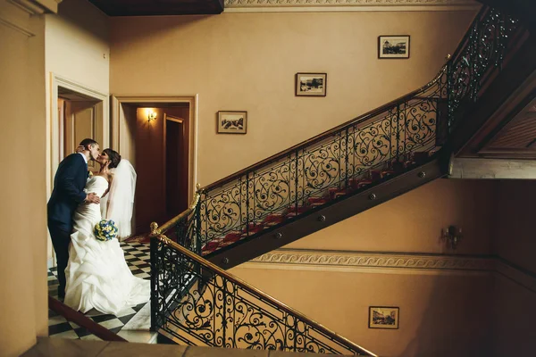 Brudgummen och bruden kramas och kyssas — Stockfoto