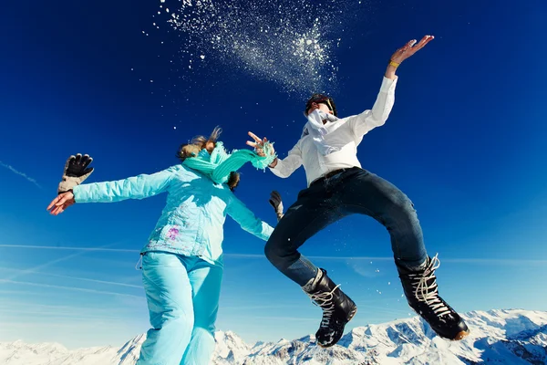 Menina e menino em salto terno de esqui — Fotografia de Stock