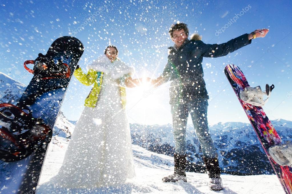bride and groom in love throw snow