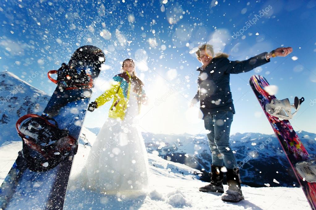 bride and groom in love throw snow