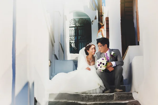 Groom and bride sitting on stairs — Stock Photo, Image